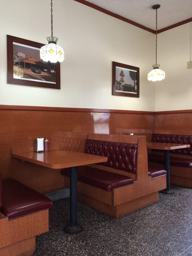 Corner booth at Pete's beneath framed photographs of the original stand